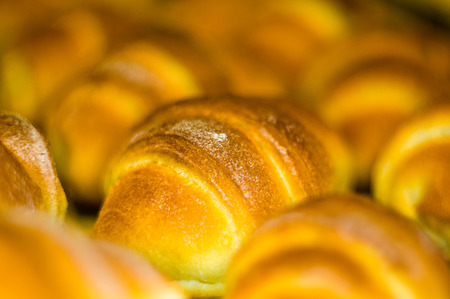 Fresh homemade croissants with sweet filling, before baking in the oven, selective focusの写真素材