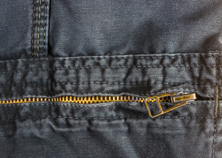 clothing items washed cotton fabric texture with seams, clasps, buttons, zippers and rivets, macro, close-upの写真素材