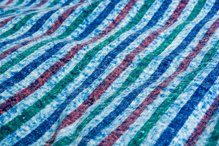 Blue washed faded jeans striped texture with seams, clothing items, macro, close-up