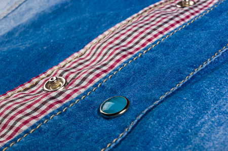 Blue washed faded jeans texture with seams, clasps, buttons and rivets, clothing items, macro,...