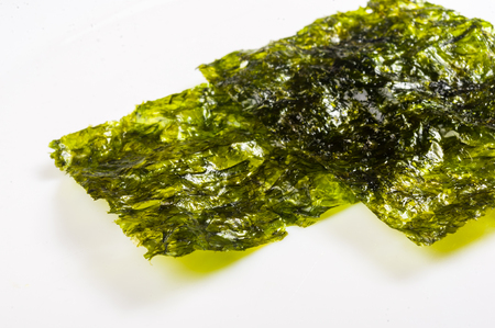 nori chips on a white ceramic plate, seaweed sheets, macro, close-up, textureの写真素材