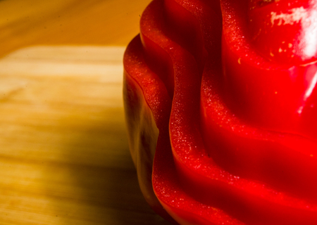 stacked pile of sliced fresh red paprika, bell pepper on bamboo cutting Board, close upの写真素材