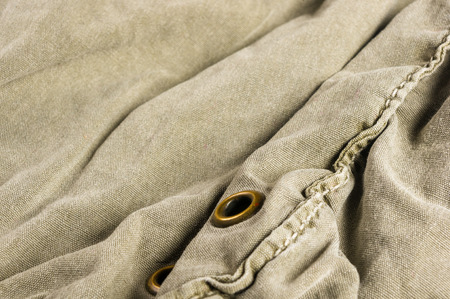 clothing items washed cotton fabric texture with seams, clasps, buttons and rivets, macro, close-upの写真素材