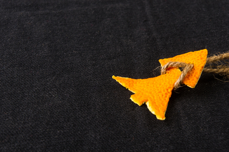 New Year Concept. Christmas decorations from tangerine peel on black backgroundの写真素材