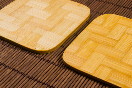 brown bamboo Mat - stand food with bamboo stands for hot, close-up, macro, wooden backgroundの写真素材