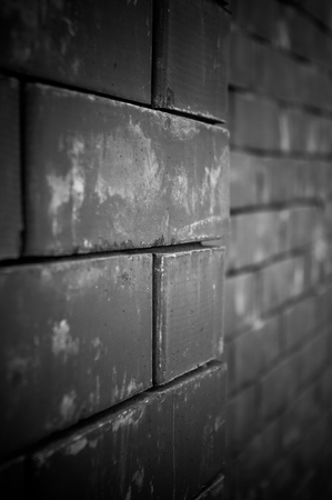 Weathered horizontal old grungy dark red brick wall, blocks of brickの写真素材