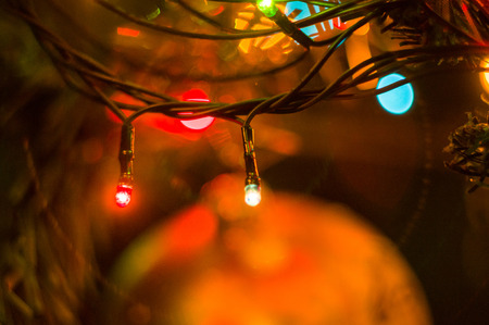 Christmas background-garlands with colorful lights on a decorated Christmas tree, bokeh, close-upの写真素材