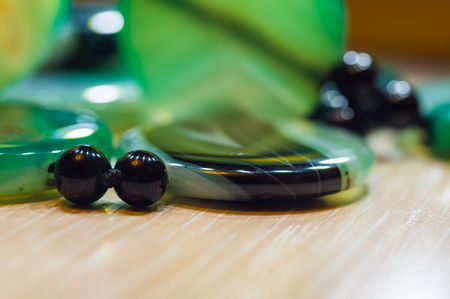 Large polished beads of beautiful translucent green agate gemstone, close-up, macro photoの写真素材