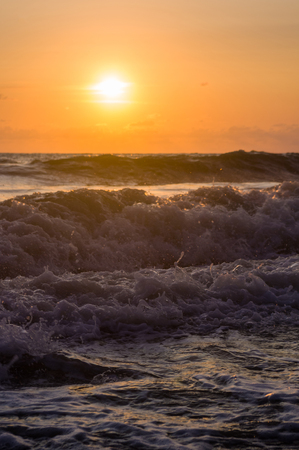 Summer sea sunset, the sun, waves and clouds, beautiful dramatic lightingの写真素材