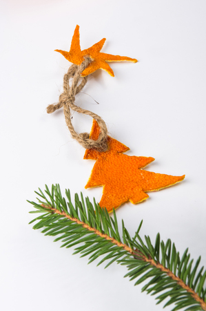 New Year Concept. Christmas decorations from tangerine peel and fir-tree branches on white backgroundの写真素材