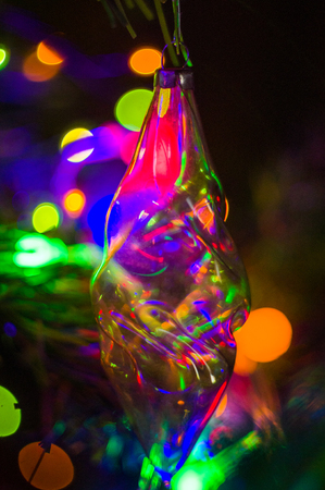 Christmas background-garlands with colorful lights on a decorated Christmas tree, bokeh, close-upの写真素材