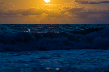 Summer sea sunset, the sun, waves and clouds, beautiful dramatic lightingの写真素材