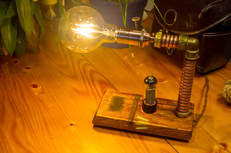 Light fixture handmade in vintage style, wooden case and radio tube, copper finish, led lampの写真素材