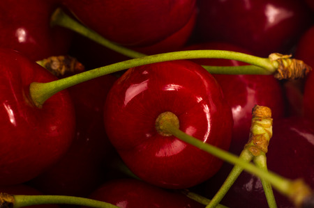 large ripe red sweet cherries on black ceramic plate, close-up, macroの写真素材