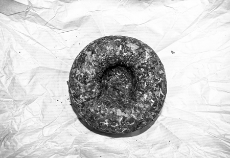 Chinese pressed puer tea on wrapping paper, close up, macroの写真素材