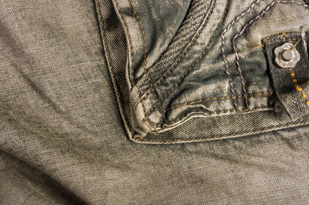 clothing items washed cotton fabric texture with seams, clasps, buttons and rivets, macro, close-upの写真素材