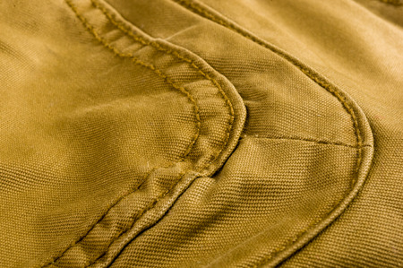 clothing items washed cotton fabric texture with seams, macro, close-upの写真素材