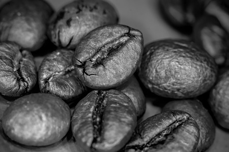 Brown roasted coffee beans on black background, close-up, macroの写真素材