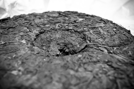 Chinese pressed puer tea on wrapping paper, close up, macroの写真素材