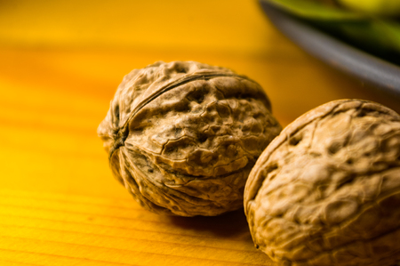 Whole walnuts on a wooden table, still life, close-upの写真素材