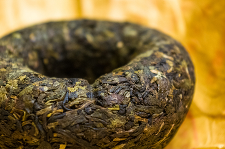Chinese pressed puer tea on wrapping paper, close up, macroの写真素材