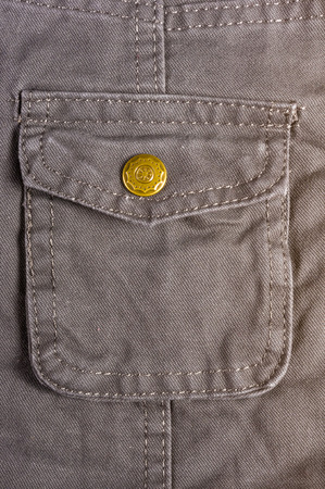 clothing items washed cotton fabric texture with seams, clasps, buttons and rivets, macro, close-upの写真素材
