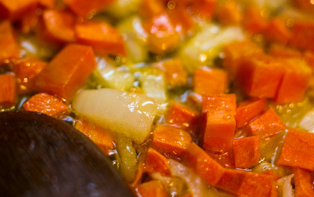 Frying finely chopped carrots and onions in boiling oilの写真素材