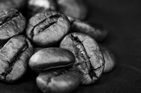 Brown roasted coffee beans on black background, close-up, macroの写真素材