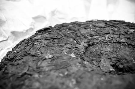 Chinese pressed puer tea on wrapping paper, close up, macroの写真素材