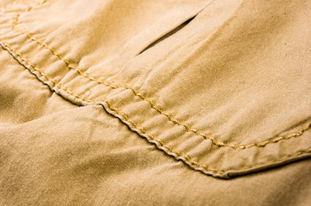 clothing items washed cotton fabric texture with seams, clasps, buttons and rivets, macro, close-upの写真素材