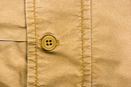 clothing items washed cotton fabric texture with seams, clasps, buttons and rivets, macro, close-up