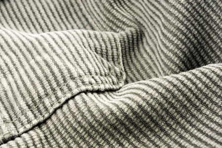 clothing items washed cotton fabric texture with seams, clasps, buttons and rivets, macro, close-up