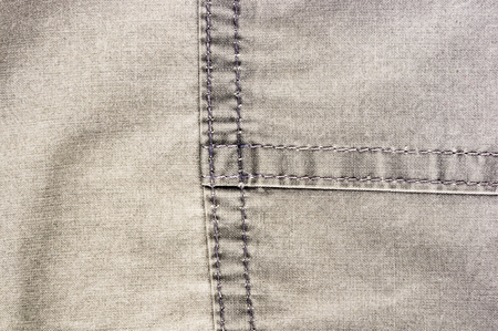 clothing items washed cotton fabric texture with seams, clasps, buttons and rivets, macro, close-up