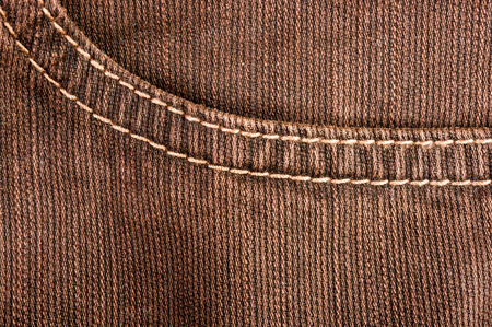clothing items washed cotton fabric texture with seams, clasps, buttons and rivets, macro, close-upの写真素材