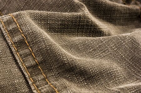clothing items stonewashed cotton fabric texture with seams, clasps, buttons and rivets, macro