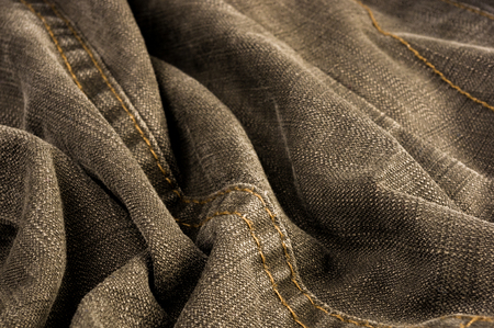 clothing items washed cotton fabric texture with seams, clasps, buttons and rivets, macro, close-upの写真素材