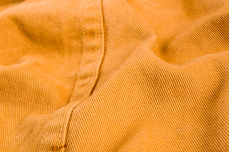 clothing items washed cotton fabric texture with seams, clasps, buttons and rivets, macro, close-up