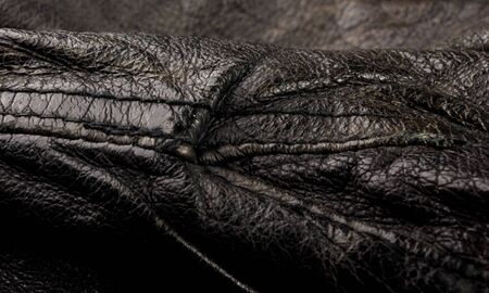 Old vintage genuine soft black leather texture background, top layer with pores and scratches, macro