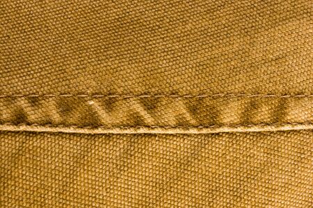 clothing items washed cotton fabric texture with seams, clasps, buttons and rivets, macro, close-up