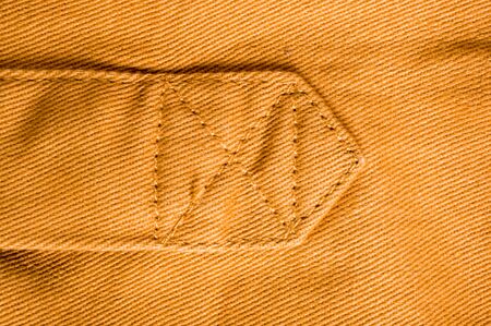 clothing items washed cotton fabric texture with seams, clasps, buttons and rivets, macro, close-up
