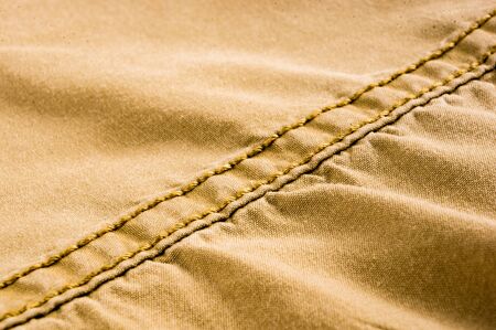 clothing items washed cotton fabric texture with seams, clasps, buttons and rivets, macro, close-up