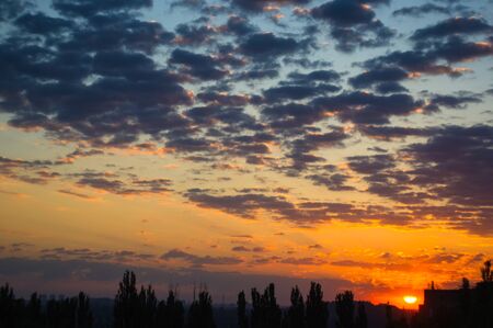 Landscape with dramatic light - beautiful golden sunset with saturated sky and clouds, peaceful...