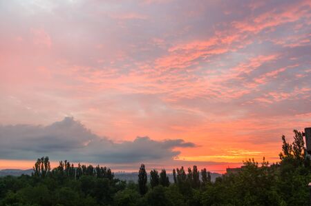 Landscape with dramatic light - beautiful golden sunset with saturated sky and clouds, peaceful nature serene background.の写真素材