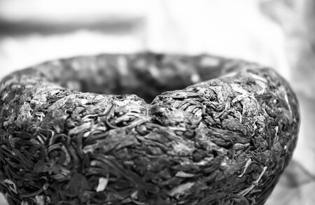 Chinese pressed puer tea on wrapping paper, close up, macroの写真素材