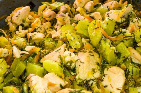 preparation of home diet dishes of white chicken meat with zucchini, carrots, onions and spicesの写真素材