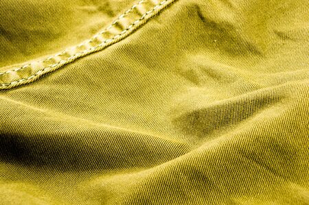 clothing items washed cotton fabric texture with seams, clasps, buttons and rivets, macro, close-up