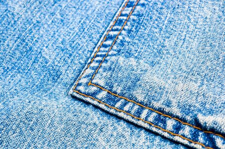 clothing items blue washed faded jeans cotton fabric texture with seams, clasps, buttons and rivets,...