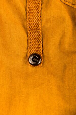 clothing items washed cotton fabric texture with seams, clasps, buttons and rivets, macro, close-up