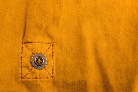 clothing items washed cotton fabric texture with seams, clasps, buttons and rivets, macro, close-up
