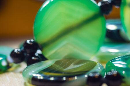 Large polished beads of beautiful translucent green agate gemstone, close-up, macro photo